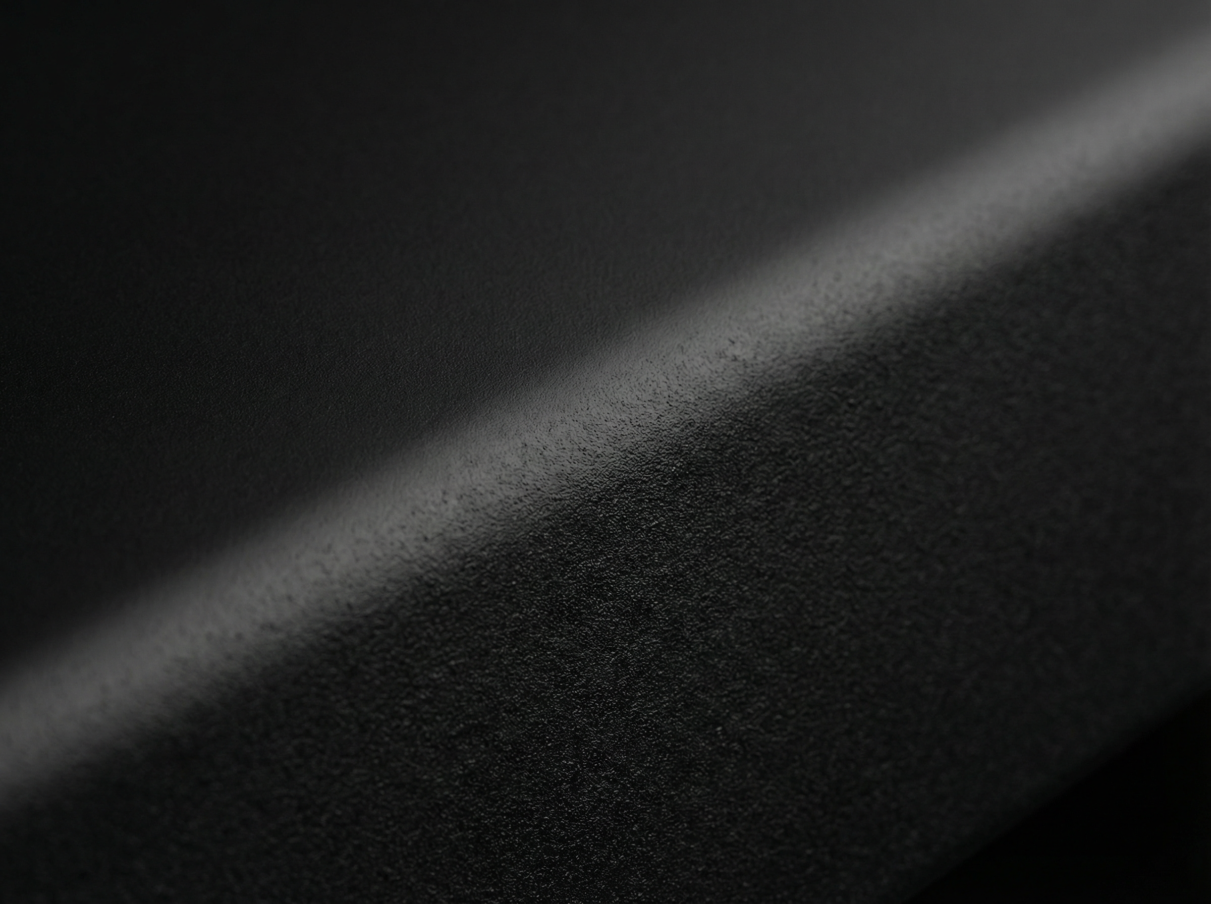 Close-up van een gestructureerde zwarte coating op een gegoten aluminium oppervlak